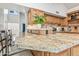 Kitchen island boasts granite countertops, a sink, and pendant lighting at 7949 W Pershing Ave, Peoria, AZ 85381