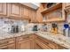 Well-equipped kitchen with custom cabinets, granite countertops, and stainless steel appliances at 7949 W Pershing Ave, Peoria, AZ 85381