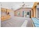 Open living room with custom built-ins, carpeted floors, vaulted ceiling and fan at 7949 W Pershing Ave, Peoria, AZ 85381