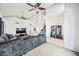 Comfortable living space with high ceilings, ceiling fans, and a huge sectional sofa and staircase at 7949 W Pershing Ave, Peoria, AZ 85381