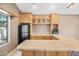 Living room with custom cabinets and bar area, tile floors, and natural light at 7949 W Pershing Ave, Peoria, AZ 85381