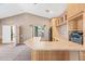 Open living room with custom cabinets and bar area and views to outdoor space at 7949 W Pershing Ave, Peoria, AZ 85381