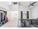 Open-concept living area with a large window, neutral decor, and a built-in storage unit at 7949 W Pershing Ave, Peoria, AZ 85381