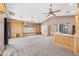Living room with custom cabinets and bar area, carpet, and natural light at 7949 W Pershing Ave, Peoria, AZ 85381