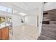 Open-concept living room with tile flooring, lots of sunlight, and a staircase at 7949 W Pershing Ave, Peoria, AZ 85381