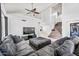 Spacious living room with a large sectional sofa, high ceilings, and stylish ceiling fans at 7949 W Pershing Ave, Peoria, AZ 85381