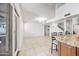 The living room leads to the kitchen with island seating and an open floor plan at 7949 W Pershing Ave, Peoria, AZ 85381
