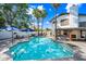 The backyard features a large in-ground pool, mature trees, and an outdoor kitchen area at 7949 W Pershing Ave, Peoria, AZ 85381