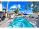 The backyard features a sparkling pool, mature trees, and a covered outdoor kitchen area at 7949 W Pershing Ave, Peoria, AZ 85381