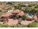 Expansive aerial view of estate showing the tile roof, pool, multiple patios, and landscaped surroundings at 8031 N 54Th St, Paradise Valley, AZ 85253