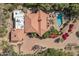 Aerial view showcasing a luxurious home with a pool, lush landscaping, and a terracotta roof at 8031 N 54Th St, Paradise Valley, AZ 85253