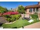 Landscaped backyard featuring a lush lawn, colorful flowers, and a comfortable seating area, ideal for outdoor relaxation at 8031 N 54Th St, Paradise Valley, AZ 85253