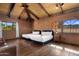 Warm bedroom with exposed brick walls, two beds, and rustic wood ceiling creating a cozy and inviting atmosphere at 8031 N 54Th St, Paradise Valley, AZ 85253