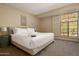 Serene bedroom features a plush bed, soft lighting, and a window offering scenic views of the surrounding landscape at 8031 N 54Th St, Paradise Valley, AZ 85253