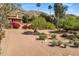 Gorgeous home with palm trees and lush landscaping, set against a backdrop of mountains at 8031 N 54Th St, Paradise Valley, AZ 85253