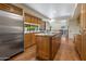 Well-lit kitchen features stainless steel appliances, wood cabinets, granite countertops, and a spacious island at 8031 N 54Th St, Paradise Valley, AZ 85253