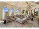 Bright living room features high ceilings, ample natural light from large windows, and a comfortable sectional sofa at 8031 N 54Th St, Paradise Valley, AZ 85253