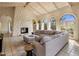 Spacious living room boasts a stone fireplace, large windows, comfortable seating, and a vaulted ceiling at 8031 N 54Th St, Paradise Valley, AZ 85253