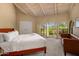Bright main bedroom featuring large windows, beamed ceilings, and a cozy seating area, perfect for relaxation at 8031 N 54Th St, Paradise Valley, AZ 85253