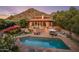 Backyard oasis with a large pool, lounge chairs, patio seating, and manicured landscaping set against a mountain backdrop at 8031 N 54Th St, Paradise Valley, AZ 85253