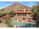 Stunning pool area with lounge chairs, patio seating, and a mountain backdrop, perfect for outdoor relaxation at 8031 N 54Th St, Paradise Valley, AZ 85253