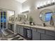 Modern bathroom with granite countertops, dual sinks, and decorative round mirrors at 8544 W Mary Ann Dr, Peoria, AZ 85382