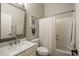 Neutral bathroom with a large mirror, vanity with sink, toilet, and shower with curtain at 8544 W Mary Ann Dr, Peoria, AZ 85382