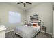Bright bedroom featuring a neutral palette, a patterned bedspread, and cozy decor at 8544 W Mary Ann Dr, Peoria, AZ 85382
