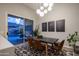 Contemporary dining room with modern light fixture, seating for six, and backyard access at 8544 W Mary Ann Dr, Peoria, AZ 85382