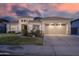 Charming single-story home features a well-manicured lawn, two-car garage and classic desert landscaping at 8544 W Mary Ann Dr, Peoria, AZ 85382