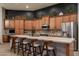 Stylish kitchen with ample cabinetry, granite countertops, stainless steel appliances, and a breakfast bar with seating at 8544 W Mary Ann Dr, Peoria, AZ 85382