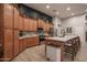 Well-equipped kitchen with ample cabinetry, granite countertops, stainless steel appliances, and a breakfast bar with seating at 8544 W Mary Ann Dr, Peoria, AZ 85382
