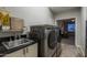Functional laundry room featuring modern washer and dryer, a sink, and convenient storage at 8544 W Mary Ann Dr, Peoria, AZ 85382