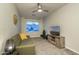 Relaxing living room featuring a comfortable green sofa, tv, and modern decor at 8544 W Mary Ann Dr, Peoria, AZ 85382