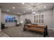 Bright living room featuring hardwood floors, a modern light fixture, and large windows at 8544 W Mary Ann Dr, Peoria, AZ 85382
