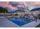 Backyard pool with waterfall feature, lush landscaping, and lounge areas at 8544 W Mary Ann Dr, Peoria, AZ 85382