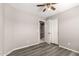 This bedroom features hardwood floors, a ceiling fan, and a closet at 8614 W Shaw Butte Dr, Peoria, AZ 85345