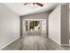 This bedroom features light gray walls, hardwood flooring, a ceiling fan, and a bay window with natural light at 8614 W Shaw Butte Dr, Peoria, AZ 85345