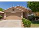 Inviting single-story home features a two-car garage and manicured landscaping at 8614 W Shaw Butte Dr, Peoria, AZ 85345
