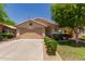 Charming single-story home with a well-manicured front yard and a two-car garage at 8614 W Shaw Butte Dr, Peoria, AZ 85345
