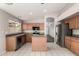 Modern kitchen featuring stainless steel appliances, an island, and tile flooring at 8614 W Shaw Butte Dr, Peoria, AZ 85345