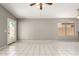 Open-concept room with neutral tile flooring and a sliding door to outdoor area at 8614 W Shaw Butte Dr, Peoria, AZ 85345