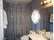 Compact bathroom featuring a shower curtain, vanity, and toilet at 9203 W Behrend Dr, Peoria, AZ 85382
