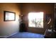 Bedroom featuring carpet floors, a large window, and light-colored walls at 9203 W Behrend Dr, Peoria, AZ 85382