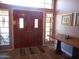 Warm and inviting foyer featuring wood floors, double doors, and decorative accents at 9203 W Behrend Dr, Peoria, AZ 85382