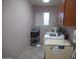 Functional laundry room with washer, dryer, and storage at 9203 W Behrend Dr, Peoria, AZ 85382