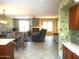 Open living area featuring neutral tones, a cozy fireplace, and tile flooring at 9203 W Behrend Dr, Peoria, AZ 85382