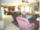 Open-concept living space with tiled floors, kitchen bar, and many seating options at 9203 W Behrend Dr, Peoria, AZ 85382