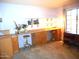 Bright office space with built-in desk, shelving, and natural light at 9203 W Behrend Dr, Peoria, AZ 85382