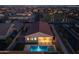 Aerial view of a single-Gathering home, neighborhood, and nearby park at dusk at 9612 E Rainbow Ave, Mesa, AZ 85212